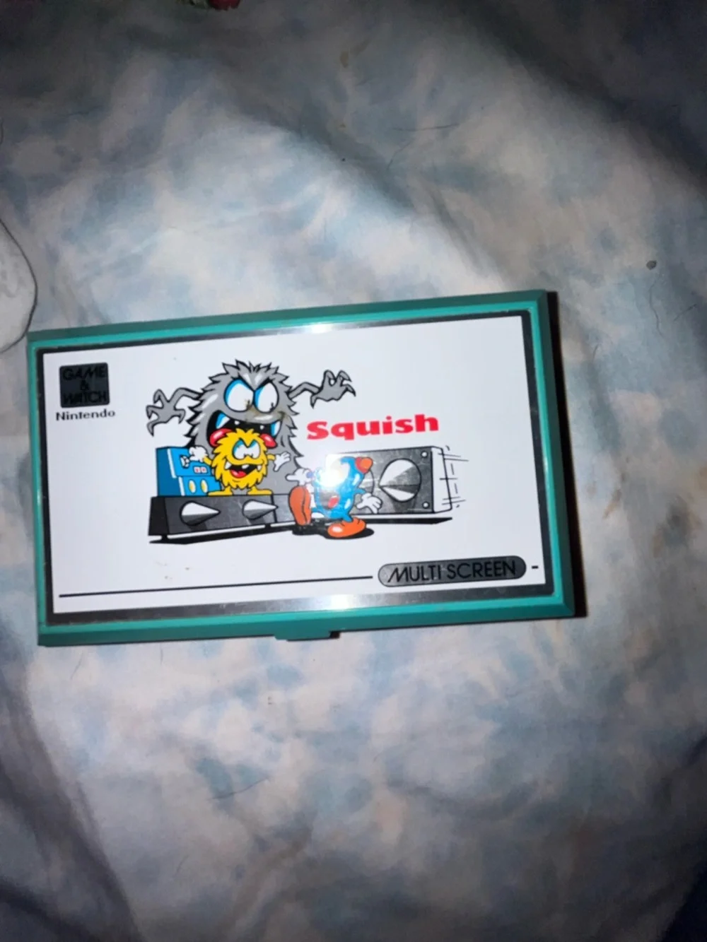 Nintendo Squish Clamshell Handheld in Teal, White and Red Buttons. Works